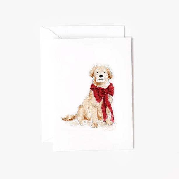 A white greeting card with a watercolor illustration of a light tan dog wearing a large red bow, shown with a matching white envelope on a light gray background.