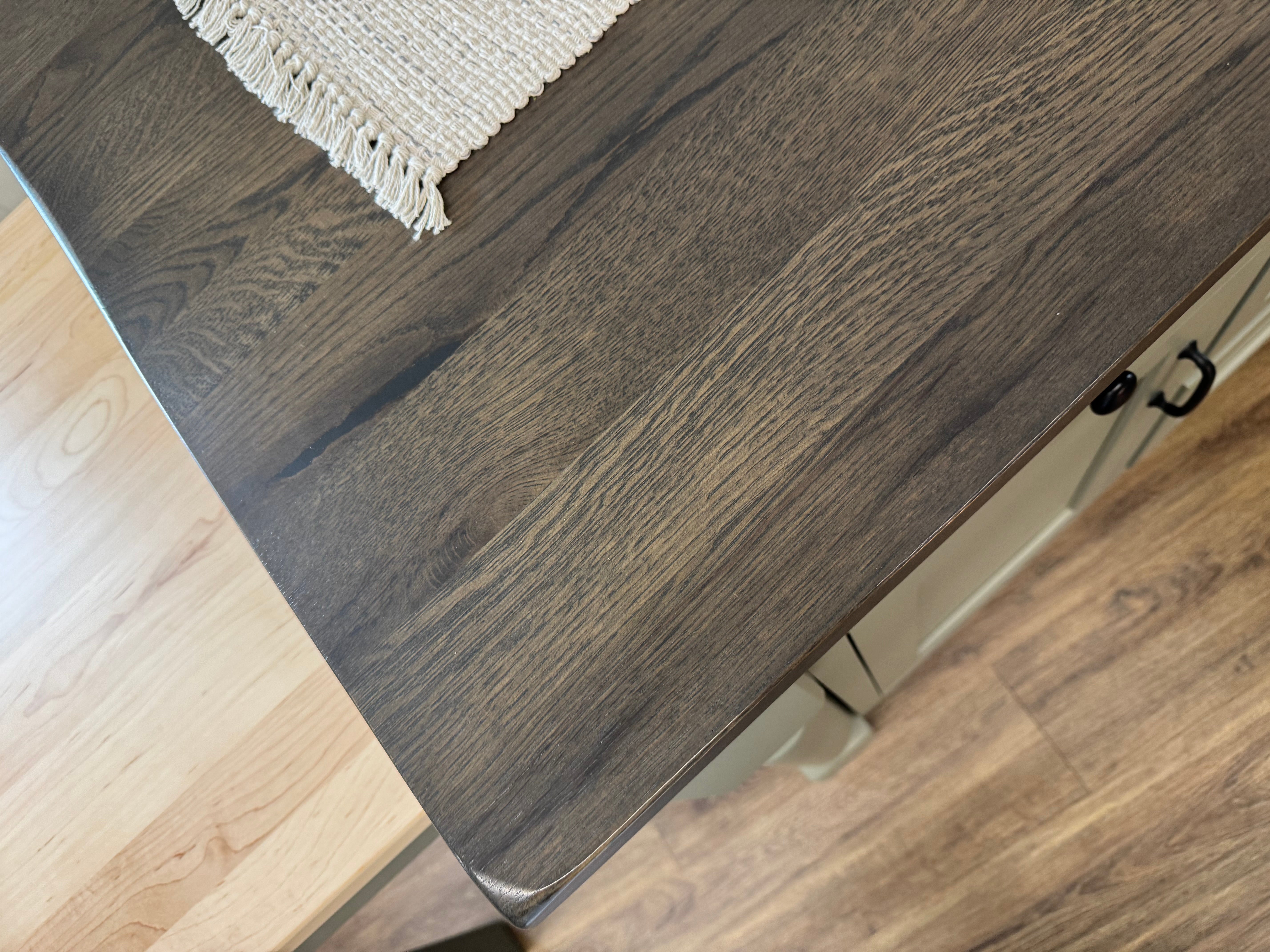 Close up detail view of an Amish made solid hardwood kitchen island with five drawers and two doors and a slide out table extension on the left side - handcrafted furniture