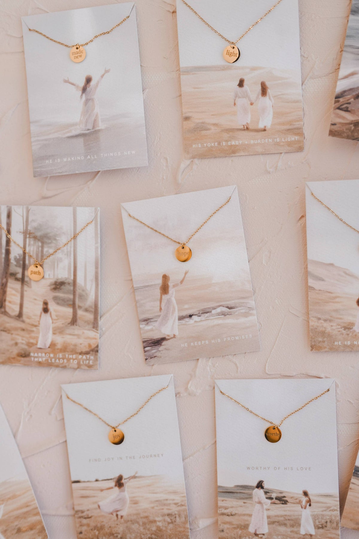 Necklace with a small round pendant displayed on scenic cards.
