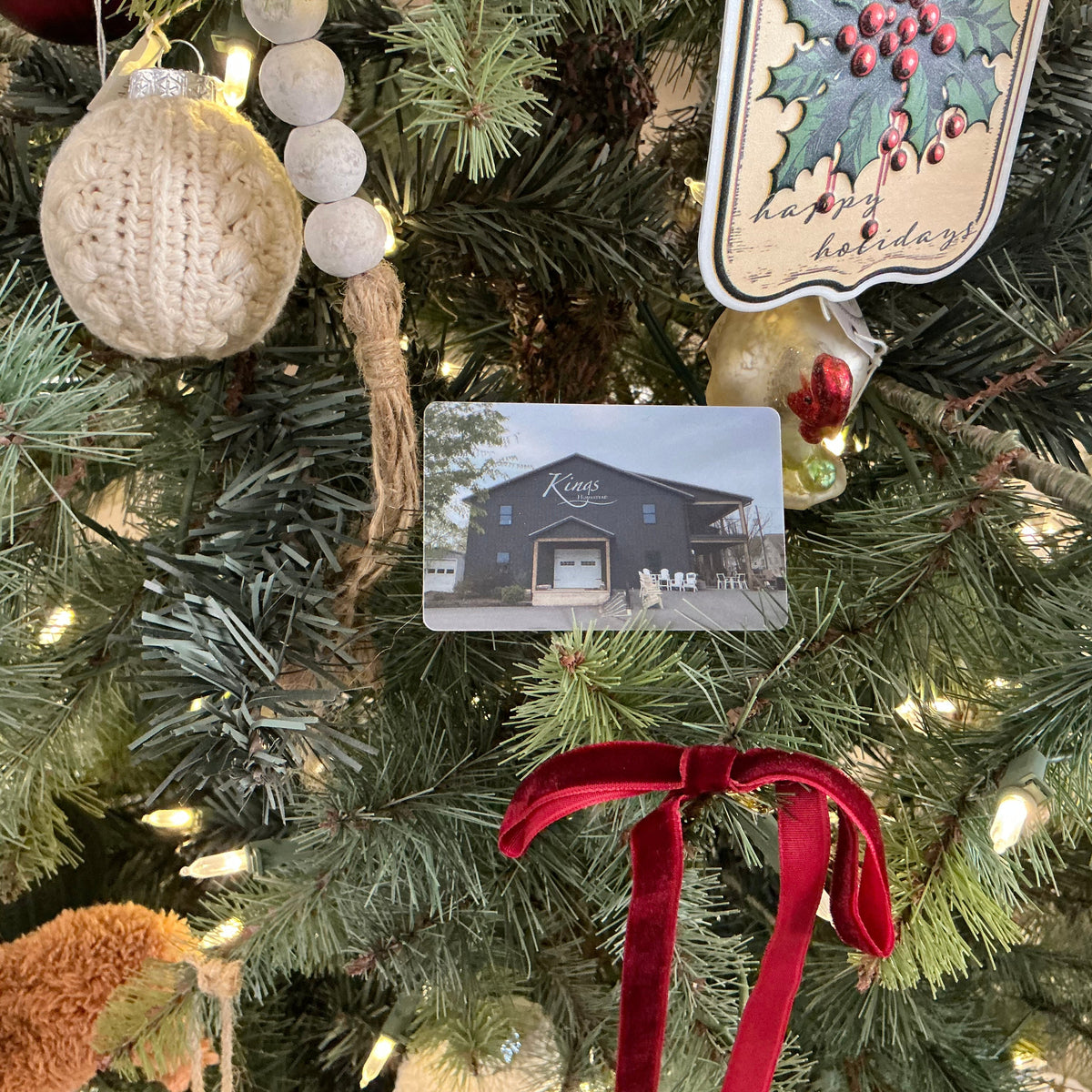 King's Homestead gift card nestled in a Christmas tree